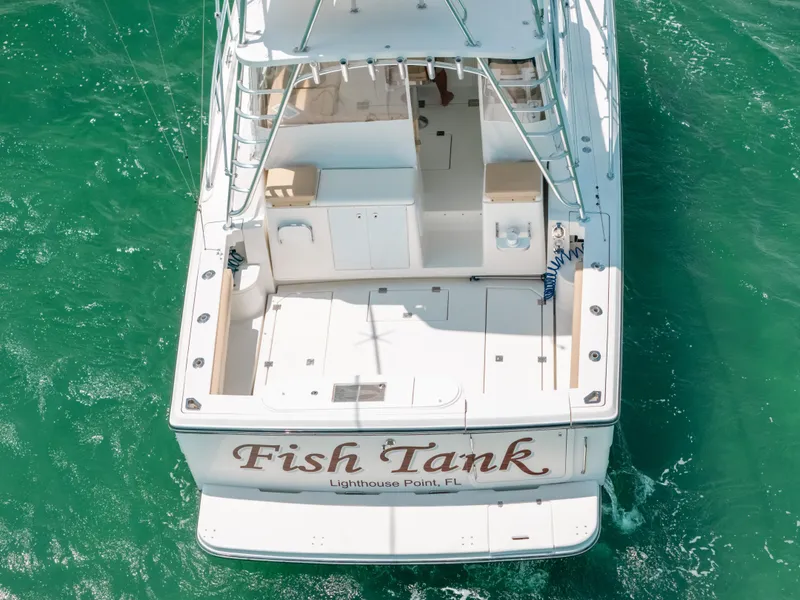 Slide: The Image of 2007 Rampage 38 Express boat named "Fish Tank" on turquoise water. - 17