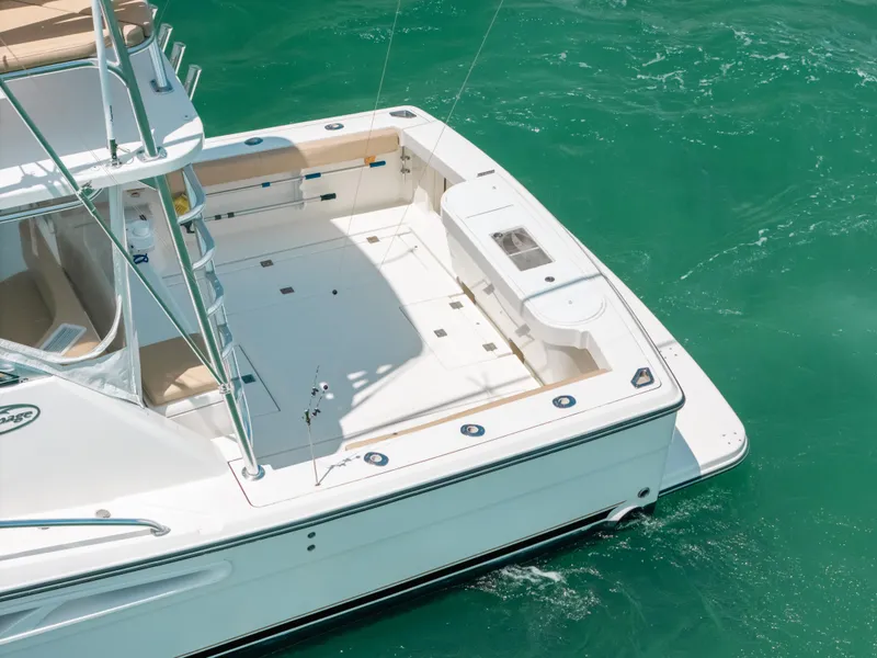 Slide: The Image of 2007 Rampage 38 Express boat on turquoise water, featuring spacious deck and fishing amenities. - 19