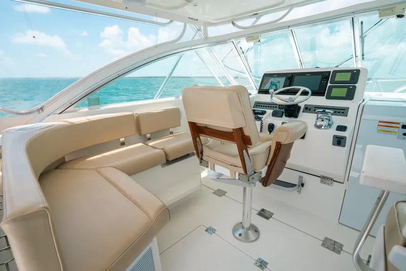 Slide: The Image of Luxurious 2007 Rampage 38 Express yacht interior with helm and seating, overlooking the ocean. - 2