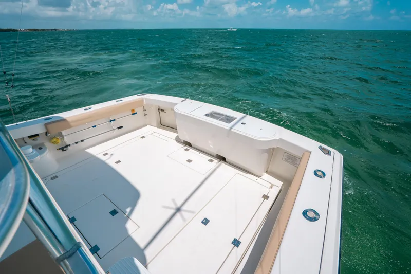 Slide: The Image of 2007 Rampage 38 Express boat deck with ocean view under clear skies. - 21