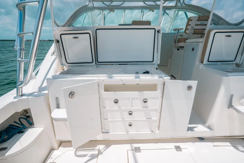 Slide: The Image of 2007 Rampage 38 Express boat interior with open storage compartments and drawers. - 23