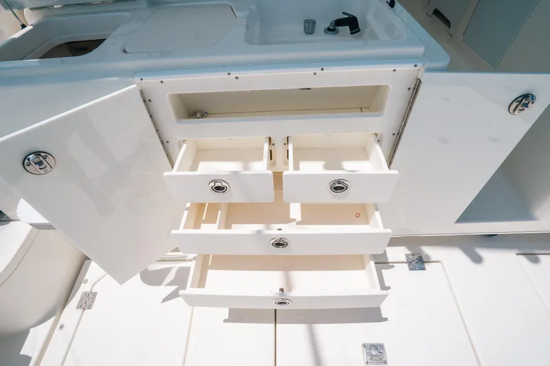 Slide: The Image of Open storage drawers and cabinet on 2007 Rampage 38 Express boat. - 24