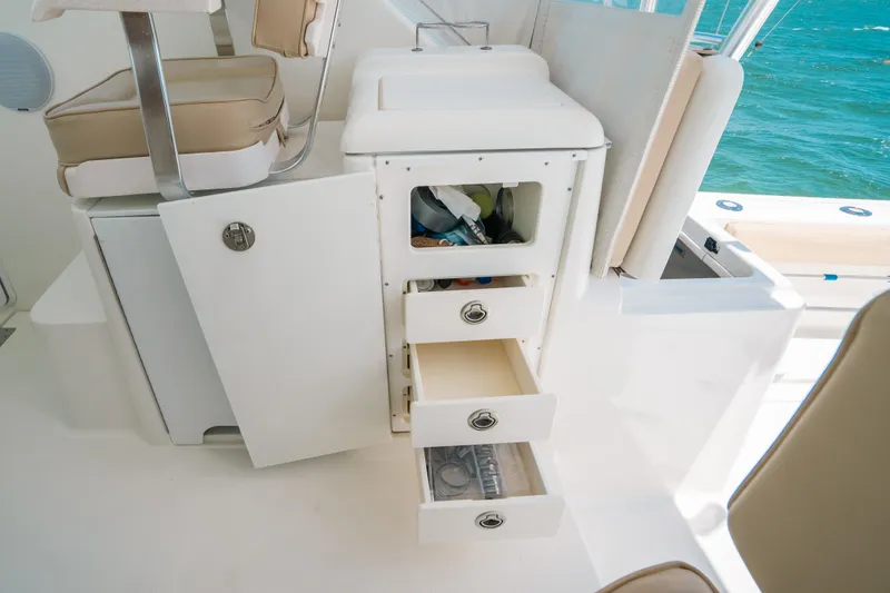 Slide: The Image of 2007 Rampage 38 Express boat interior with open storage compartments and drawers. - 26