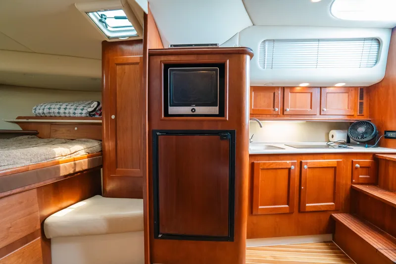 Slide: The Image of Interior of 2007 Rampage 38 Express yacht with kitchen and sleeping area. - 28