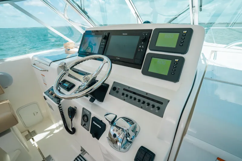 Slide: The Image of Control panel of 2007 Rampage 38 Express boat with navigation equipment and steering wheel. - 3