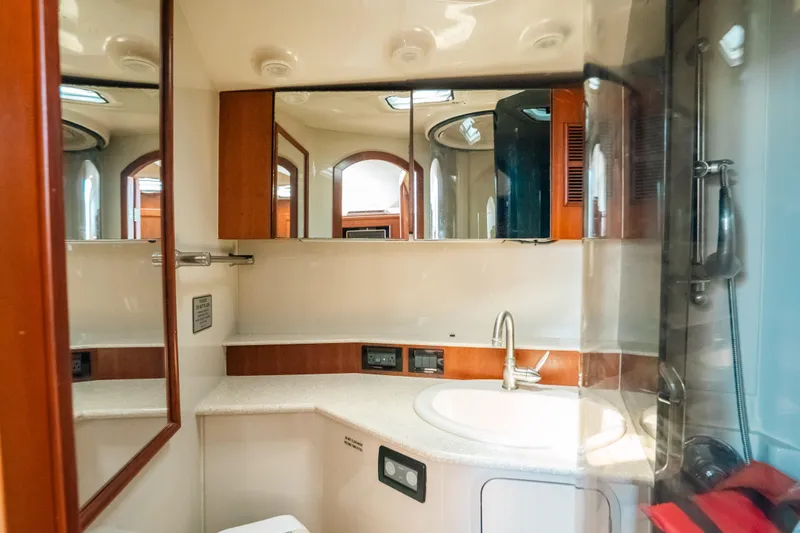 Slide: The Image of 2007 Rampage 38 Express yacht bathroom with modern fixtures and mirrored cabinets. - 32