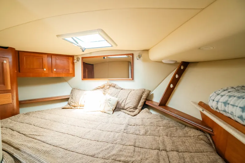 Slide: The Image of Cozy cabin interior of 2007 Rampage 38 Express with bed and wooden cabinetry. - 34