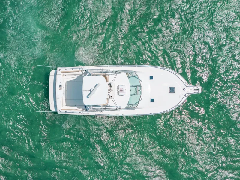 Slide: The Image of Aerial view of 2007 Rampage 38 Express boat on green water. - 38