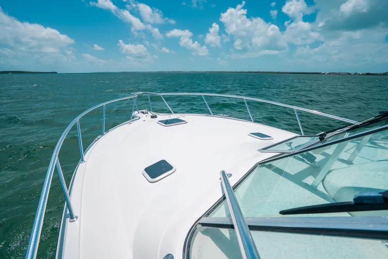 Slide: The Image of 2007 Rampage 38 Express boat cruising on open water under a clear blue sky. - 43