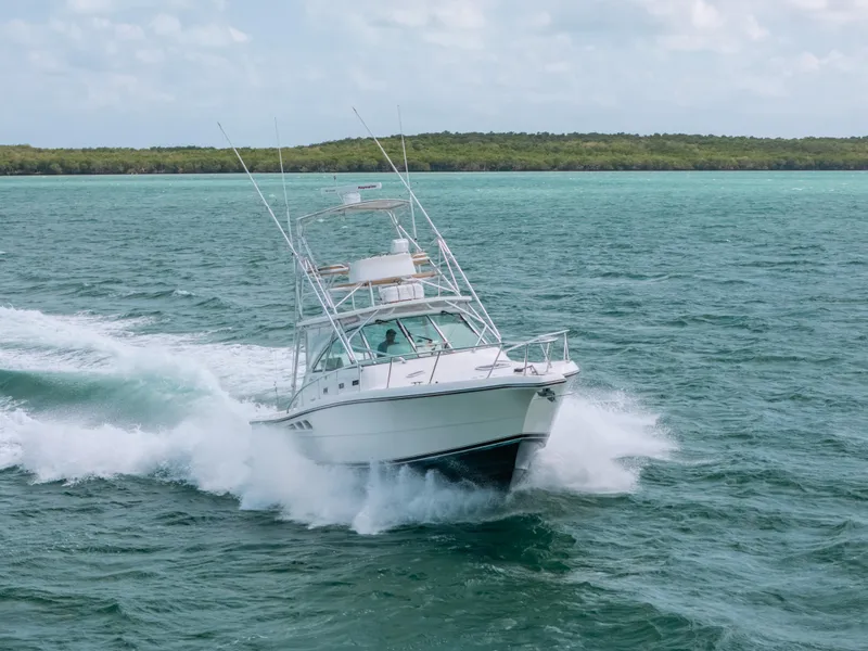 Slide: The Image of 2007 Rampage 38 Express boat cruising on open water. - 44