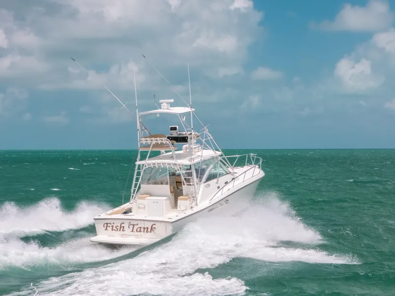 Slide: The Image of 2007 Rampage 38 Express boat cruising on open sea under clear skies. - 47