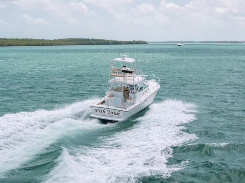 Slide: The Image of 2007 Rampage 38 Express boat cruising on turquoise waters. - 48