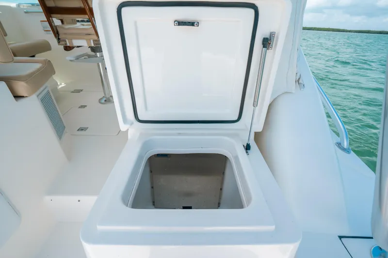 Slide: The Image of Open storage compartment on 2007 Rampage 38 Express boat deck, near ocean. - 7