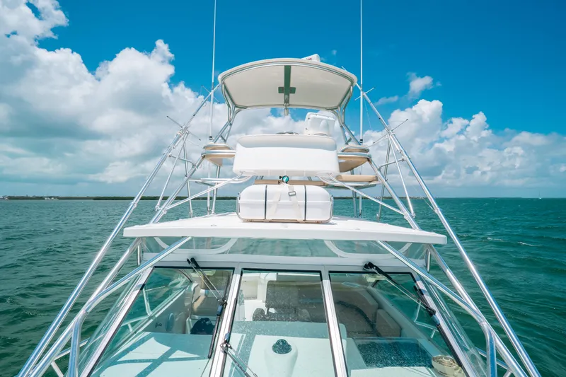 Slide: The Image of 2007 Rampage 38 Express yacht on open sea under clear blue sky. - 8