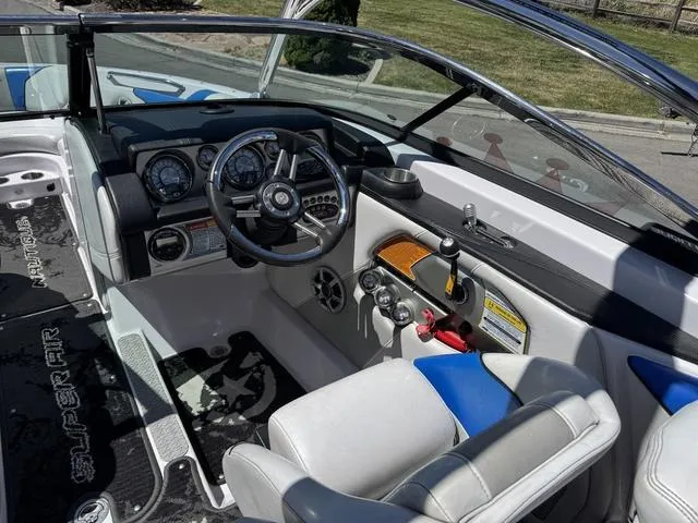 Slide: The Image of 2008 Nautique 230 TEAM EDITION boat interior with steering wheel and dashboard controls. - 10