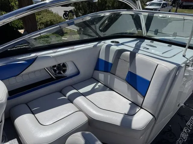 Slide: The Image of 2008 Nautique 230 TEAM EDITION boat interior with blue and white seating. - 11