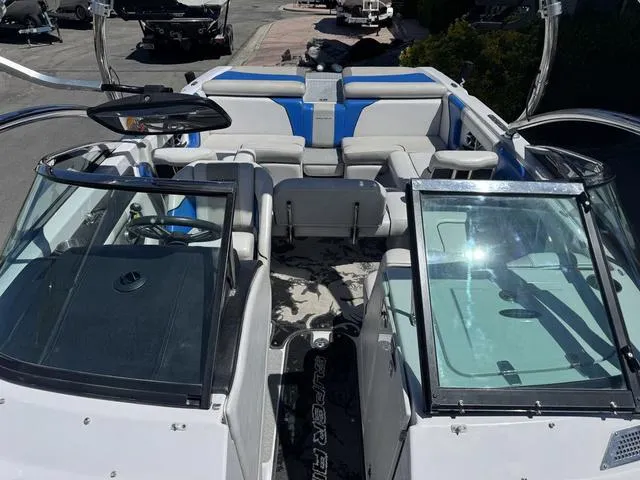 Slide: The Image of 2008 Nautique 230 TEAM EDITION boat interior with blue and white seating, open windshield. - 14