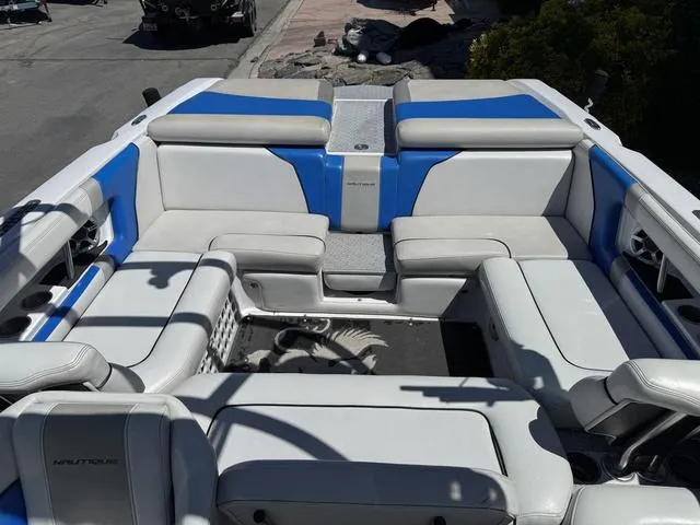 Slide: The Image of 2008 Nautique 230 TEAM EDITION boat interior with blue and white seating. - 15