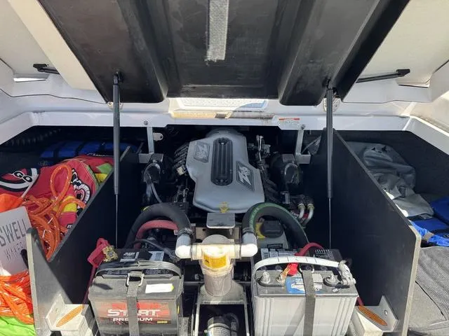 Slide: The Image of Engine compartment of a 2008 Nautique 230 TEAM EDITION boat with visible batteries and equipment. - 16