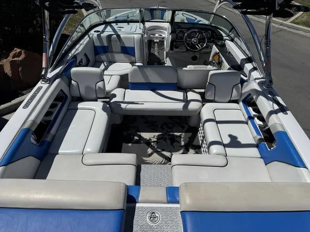 Slide: The Image of 2008 Nautique 230 TEAM EDITION boat interior with blue and white seating, steering wheel visible. - 9