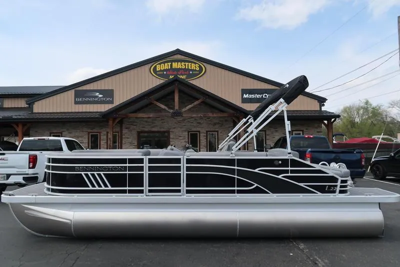 Slide: The Image of 2025 Bennington L Swingback 23 LSB pontoon boat outside dealership. - 0