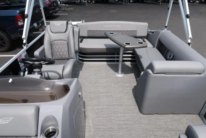 Slide: The Image of 2025 Bennington L Swingback 23 LSB pontoon boat interior with gray seating and table. - 10