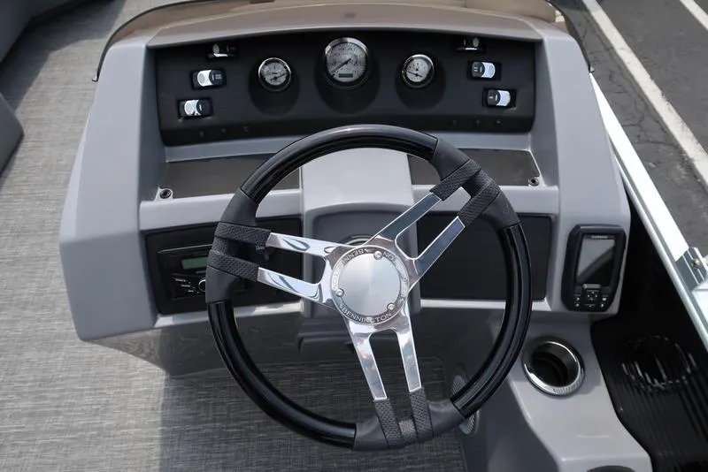 Slide: The Image of Steering console of 2025 Bennington L Swingback 23 LSB pontoon boat, featuring modern controls. - 12