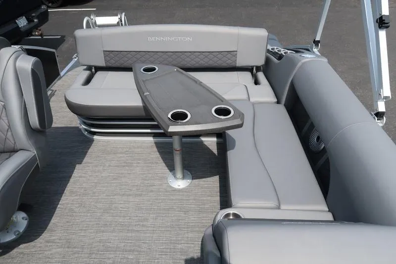 Slide: The Image of 2025 Bennington L Swingback 23 LSB boat interior with gray seating and table. - 14