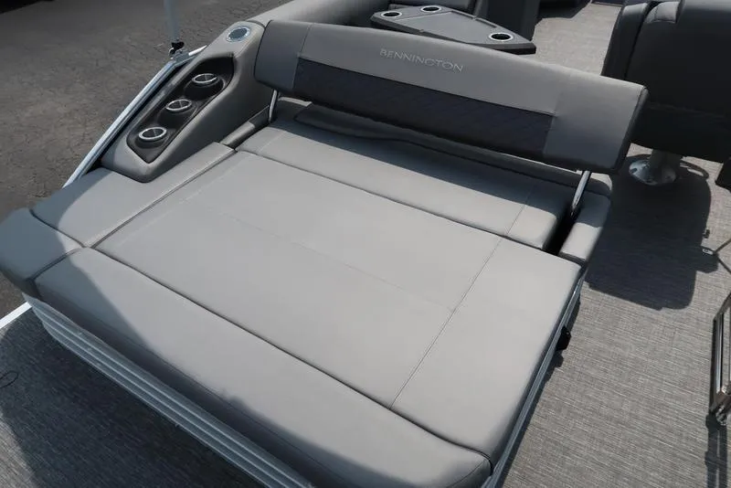 Slide: The Image of 2025 Bennington L Swingback 23 LSB boat with gray cushioned seating and cup holders. - 15
