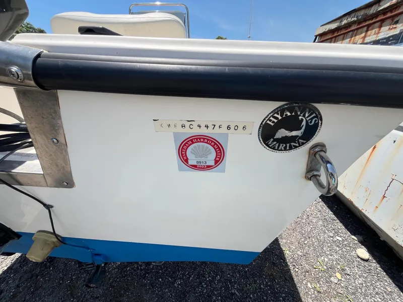 Slide: The Image of 2006 Key West 1720 Center Console boat with registration stickers and marina logo. - 11