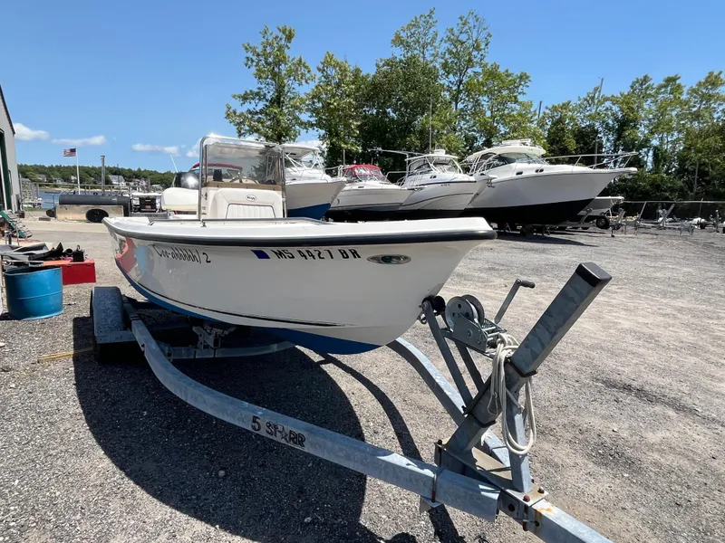 Slide: The Image of 2006 Key West 1720 Center Console boat on trailer in a marina setting. - 12