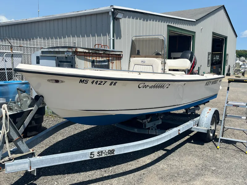 Slide: The Image of 2006 Key West 1720 Center Console boat on trailer outside a metal building. - 13