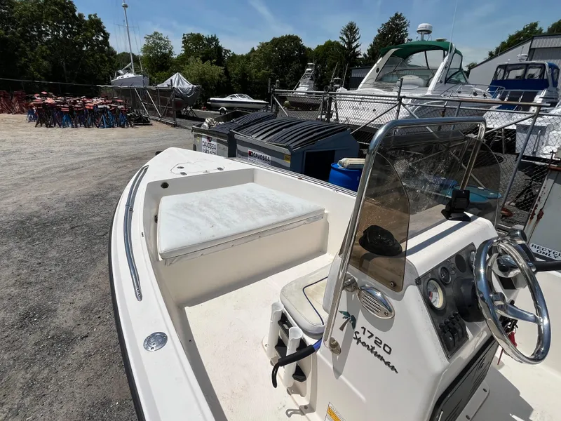 Slide: The Image of 2006 Key West 1720 Center Console boat in a marina, surrounded by other vessels. - 3