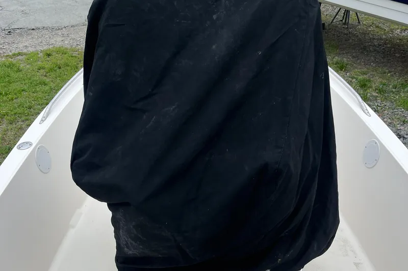 Slide: The Image of 2006 Key West 1720 Center Console boat with a black cover, parked on grass. - 9