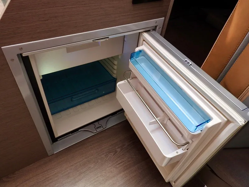 Slide: The Image of Open refrigerator on 2023 Beneteau Flyer 9 SUNdeck boat, showcasing interior storage space. - 15
