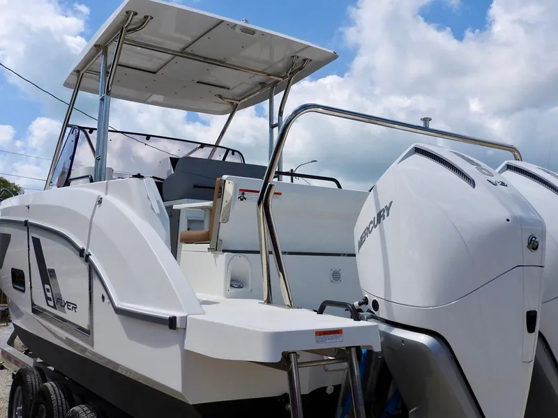 Slide: The Image of 2023 Beneteau Flyer 9 SUNdeck boat with dual Mercury engines, under a partly cloudy sky. - 32