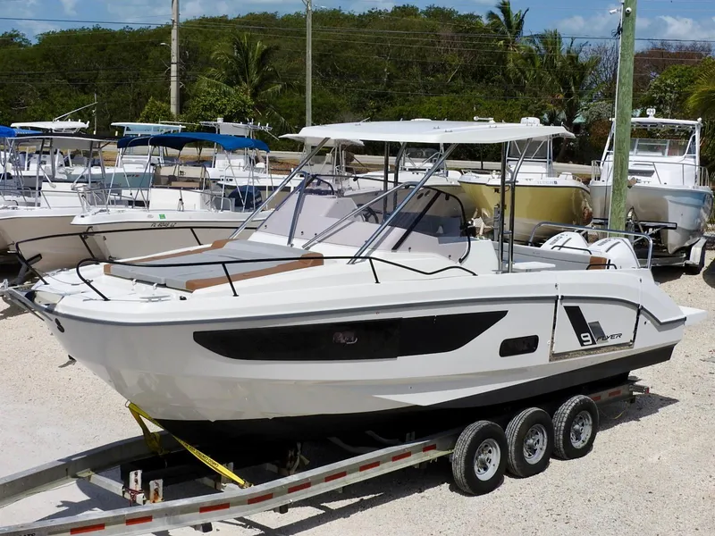 Slide: The Image of 2023 Beneteau Flyer 9 SUNdeck boat on trailer, parked in marina. - 35