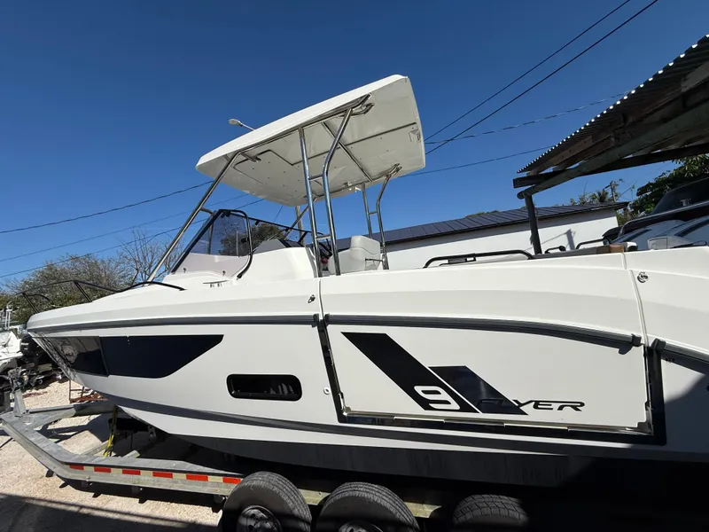 Slide: The Image of 2023 Beneteau Flyer 9 SUNdeck boat on trailer under clear blue sky. - 36