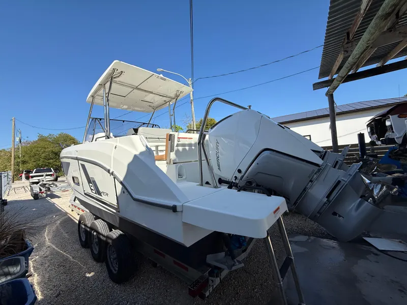 Slide: The Image of 2023 Beneteau Flyer 9 SUNdeck boat on trailer, featuring dual outboard engines. - 37