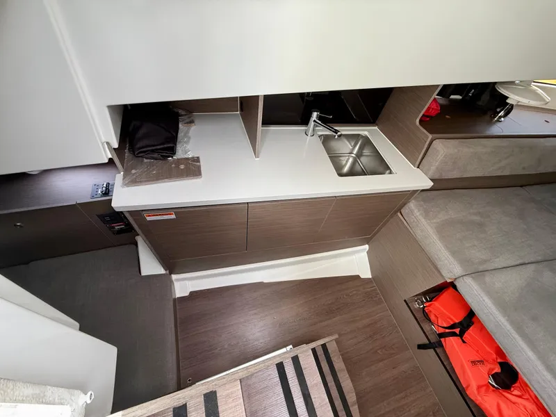 Slide: The Image of Interior of 2023 Beneteau Flyer 9 SUNdeck, featuring compact kitchenette and seating area. - 40