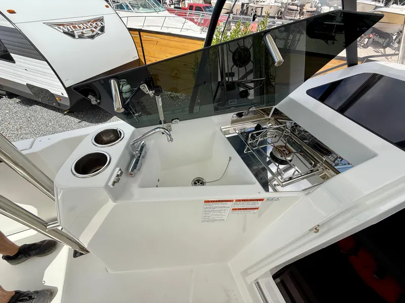 Slide: The Image of 2023 Beneteau Flyer 9 SUNdeck kitchenette with sink and stove, outdoor setting. - 42