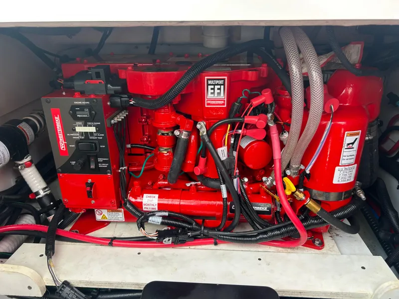 Slide: The Image of Engine compartment of 2023 Beneteau Flyer 9 SUNdeck, featuring a red marine engine. - 47