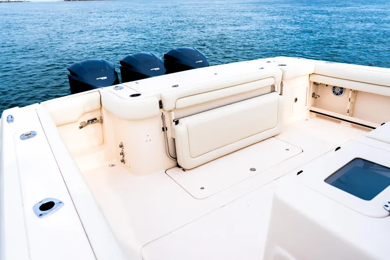 Slide: The Image of 2015 Grady-White Canyon 376 boat deck with triple outboard motors on the water. - 10