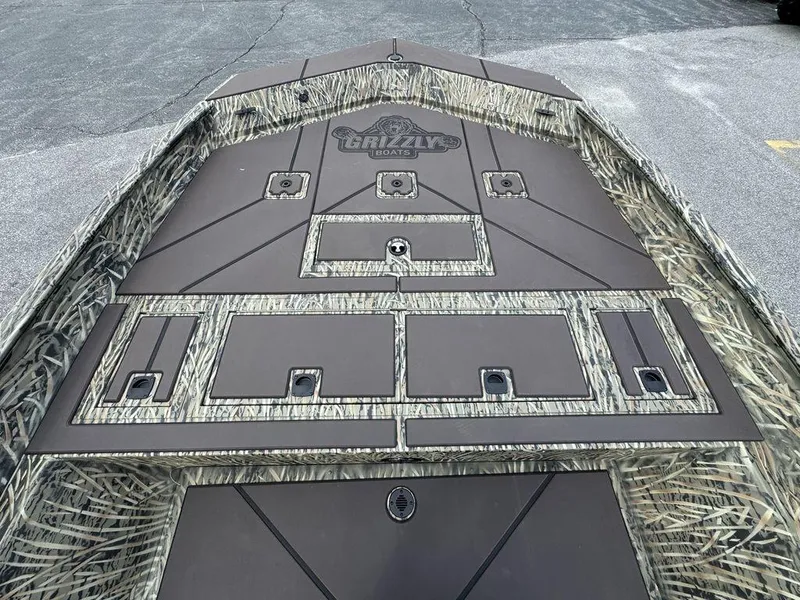 Slide: The Image of 2025 Tracker GRIZZLY® 2072 CC boat deck with camo pattern and storage compartments. - 10