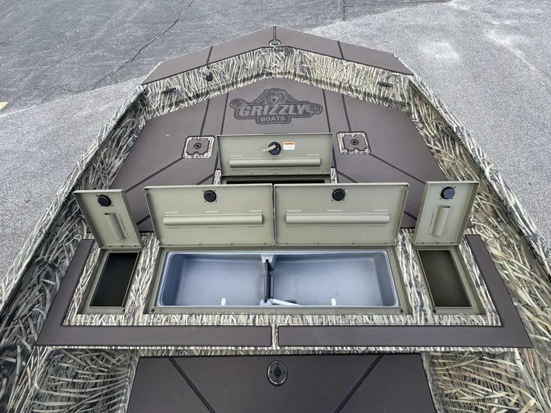 Slide: The Image of 2025 Tracker GRIZZLY® 2072 CC boat deck with storage compartments open. - 12