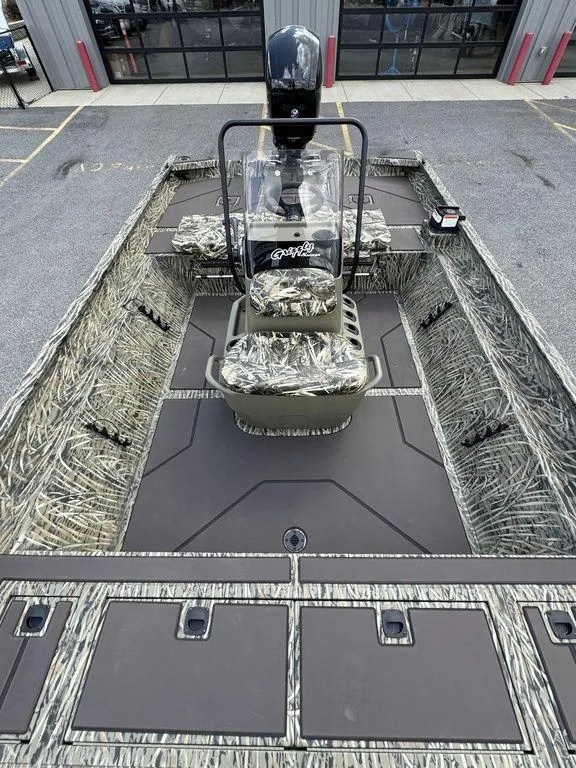 Slide: The Image of 2025 Tracker GRIZZLY® 2072 CC boat with camouflage interior and center console. - 13