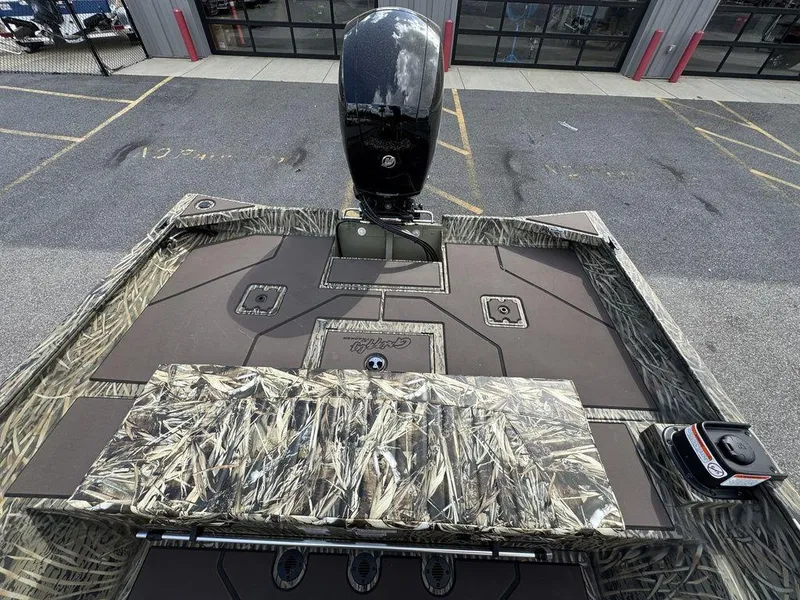 Slide: The Image of 2025 Tracker GRIZZLY® 2072 CC boat with camouflage deck and powerful outboard motor. - 16