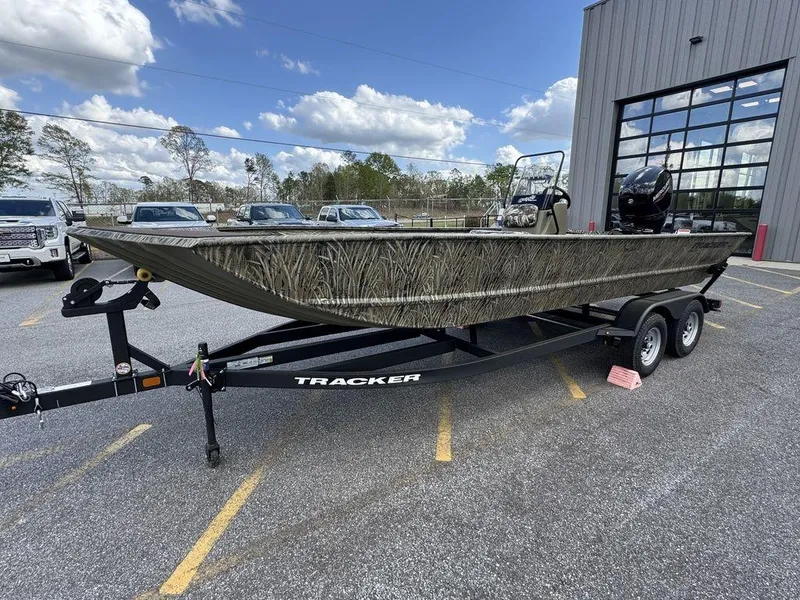 Slide: The Image of 2025 Tracker GRIZZLY® 2072 CC boat on trailer, parked outdoors near a building. - 3