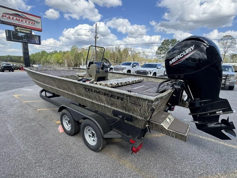 Slide: The Image of 2025 Tracker GRIZZLY® 2072 CC boat with Mercury engine on trailer, parked outdoors. - 5