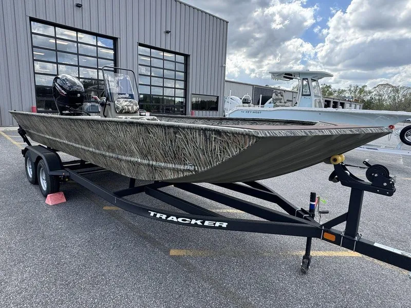 Slide: The Image of 2025 Tracker GRIZZLY® 2072 CC boat on trailer, parked outdoors near a building. - 8